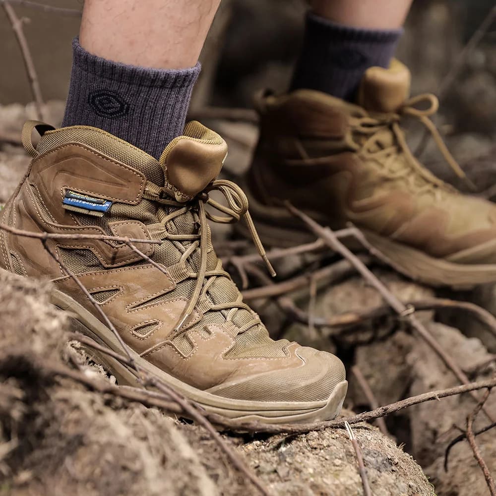 Walker combat boots in a rocky outdoor environment